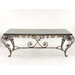 A large wrought iron garden table, with a modern granite top, top 200 x 89cm
