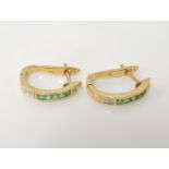 A pair of emerald and diamond channel set half hoop earrings, marked 18k, 3.0g
