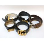 Four designer belts, including a black leather Gucci example with gilt GG monogram