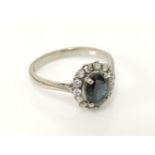 A white gold sapphire and diamond oval cluster ring, marked 18ct, 3.4g