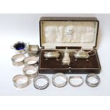 Silver items, a cased three piece cruet set, Birmingham 1930, eight napkin rings, and two small