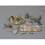 A collection of silver/metal ware miniatures, to include two playful cats, a four piece teaset on