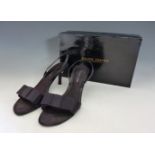 A pair of Roland Cartier black slingback shoes,with grosgrain bow to toe and satin strap to heel, in