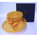 A Philip Treacy of London yellow ochre coloured straw sinamay hat, with matching coiled sinamay