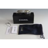 A pair of Chanel sunglasses, with tinted lenses and 'CC' monogram to central collapsible hinge, in