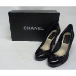 A pair of Chanel black patent leather and open mesh court heel shoes, with gilt double 'C'
