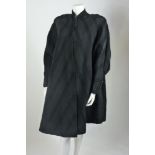 A Harvey Nichols black evening coat, c.1950, in a heavy black grosgrain fabric with gathered