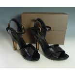 A pair of Louis Vuitton black patent leather high heel sandal shoes, with cross ribbed section to