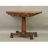 A Victorian mahogany card table, on circular support and quatrefoil base with replacement baize,