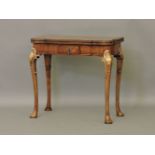 A reproduction George III walnut and gilt fold over top card table, 77.5cm wide
