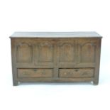 An 18th century oak dower chest, with four arched panel front and two base drawers, front cut into