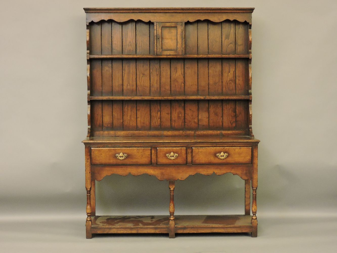 A reproduction George III style oak dresser, with rack over, 135 x 44 x 182cm