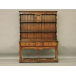 A reproduction George III style oak dresser, with rack over, 135 x 44 x 182cm
