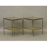 A pair of two tier lacquered brass occasional tables, the tops inset with 18th century carved Korean