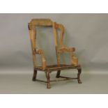 A William and Mary walnut wing back armchair frame, with shaped stretcher and square feet, old
