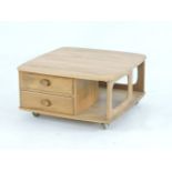 An Ercol 'Pandora's Box' coffee table, with two drawers and bookshelves, on castors, 81cm square,