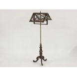 A 19th century rosewood and gilt brass duet music stand, with carved scrolling tripod base, 141cm