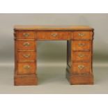 A Victorian style mahogany kneehole desk, nine drawers arranged around a central recess, 107cm wide