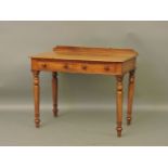 A 19th century mahogany two drawer side table, stamped 'Heals' on drawer, now lacking castors
