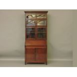 A mahogany library bureau cabinet, with three sections to the top, bevel glass panes