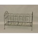 An iron folding cot, and a Victorian mahogany centre table, the circular top on a platform base,