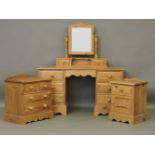 A pine dressing table, with swing mirror, and two pine bedside cabinets