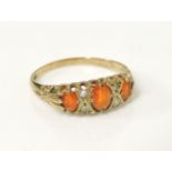 A 9ct gold three stone fire opal boat shaped ring, set with pairs of diamond set points, with F