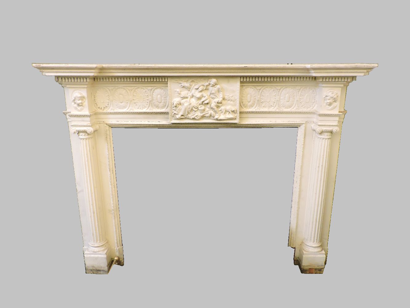 A 19th century painted fire surround, the dentil cornice above a central frieze depicting an amorous