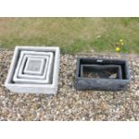 A large collection of planters, comprising two graduated sets of grey square section shallow