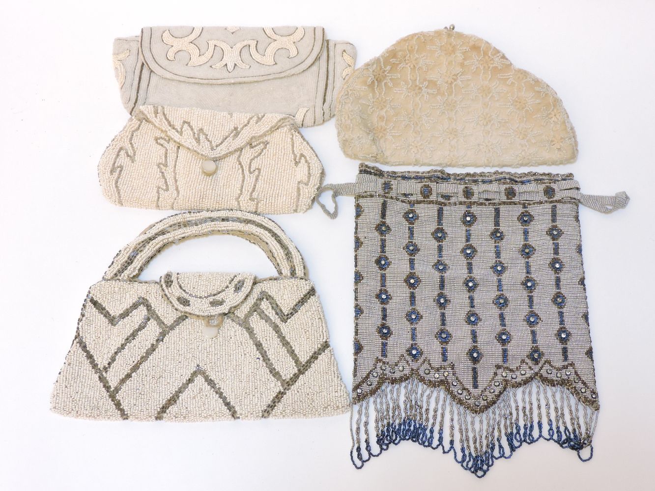 A collection of 1920s and later evening handbags, including a beaded example with blue and brown