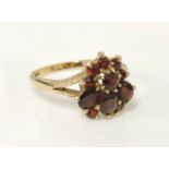 A 9ct gold garnet cluster ring, with receipt