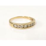 An 18ct gold seven stone diamond channel set half eternity ring, with original F Hinds certificate