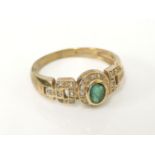 A 9ct gold emerald and diamond oval cluster ring, with diamond set chain link shoulders