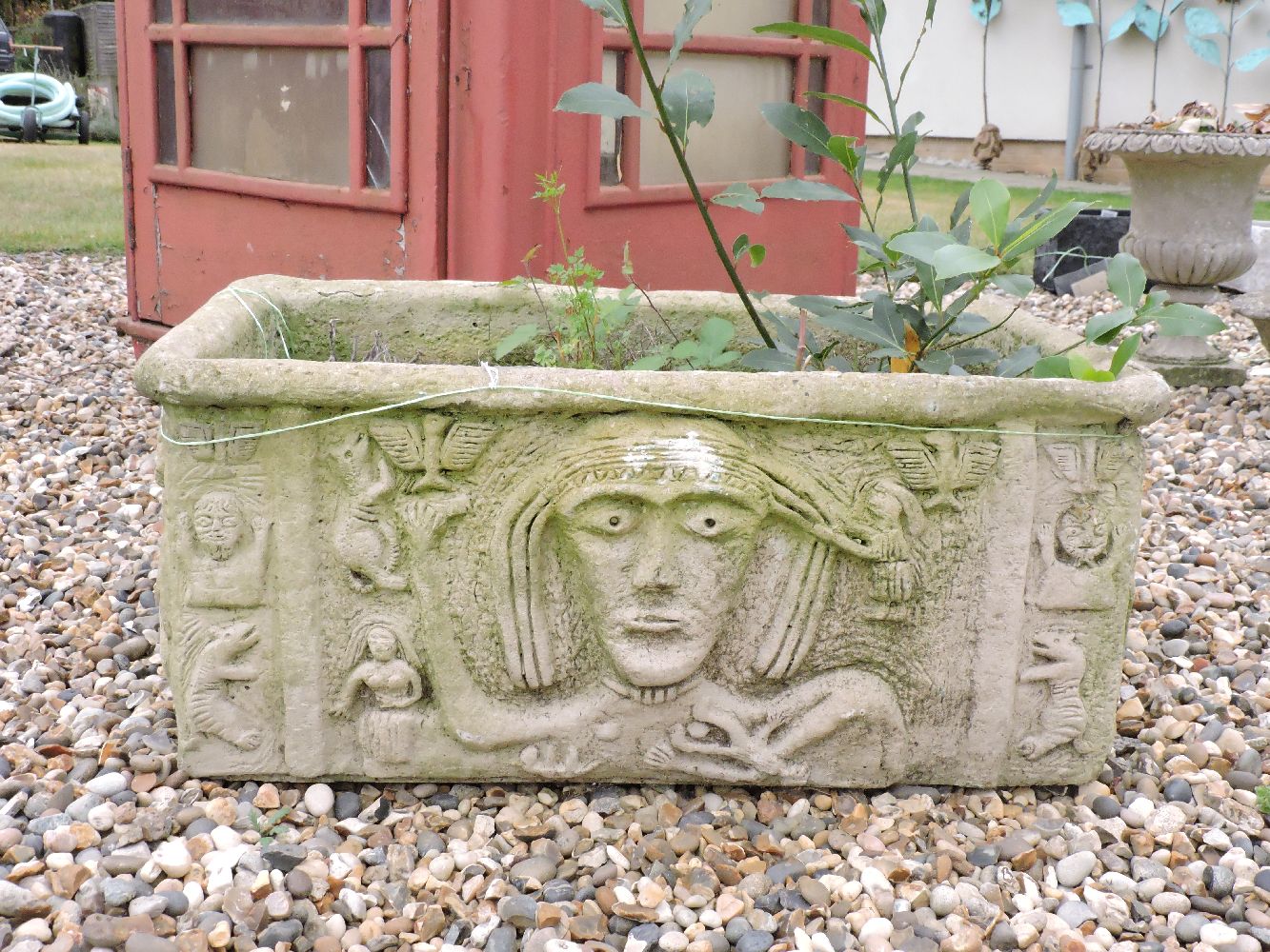 A rectangular composite planter, with tribal decoration, 77cm wide, 35cm tall, a small composite