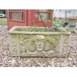 A rectangular composite planter, with tribal decoration, 77cm wide, 35cm tall, a small composite
