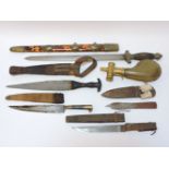 Five various daggers in scabbards, and a horn and brass powder flask