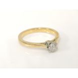 A gold single stone diamond ring, tested as approximately 18ct gold