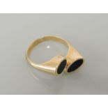A gold crossover ring, set with two black wood ovals, marked K14, 4.0g
