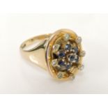 A gold sapphire and diamond oval dispersed cluster ring, later mounted to a 9ct gold signet ring,