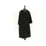 A black Astrakhan fur coat, with large collar and turned back cuffs
