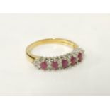 An 18ct gold five stone marquise cut ruby ring, set with fourteen diamond points