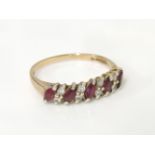 A 9ct gold five stone diagonal marquise cut half hoop ruby ring, set with eight diamond points, with