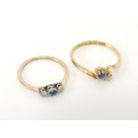 An 18ct gold sapphire and diamond crossover ring, size M½, and a gold sapphire and diamond three