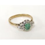 A 9ct gold emerald and diamond lozenge shaped cluster ring