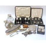 Two sets of silver teaspoons, a silver vesta sovereign holder, cigarette case, pair of napkin rings,