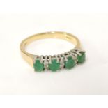 An 18ct gold four stone emerald ring, set with six diamond points, with original F Hinds certificate