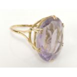 A gold oval cut pale amethyst ring, marked 18ct