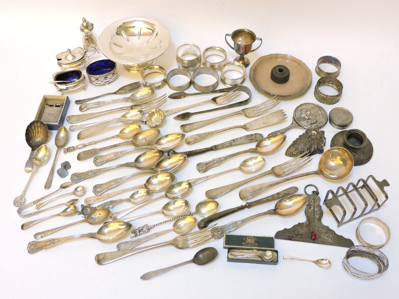 A large assortment of silver items, to include napkin ring, spoons, teaspoons, clips, etc