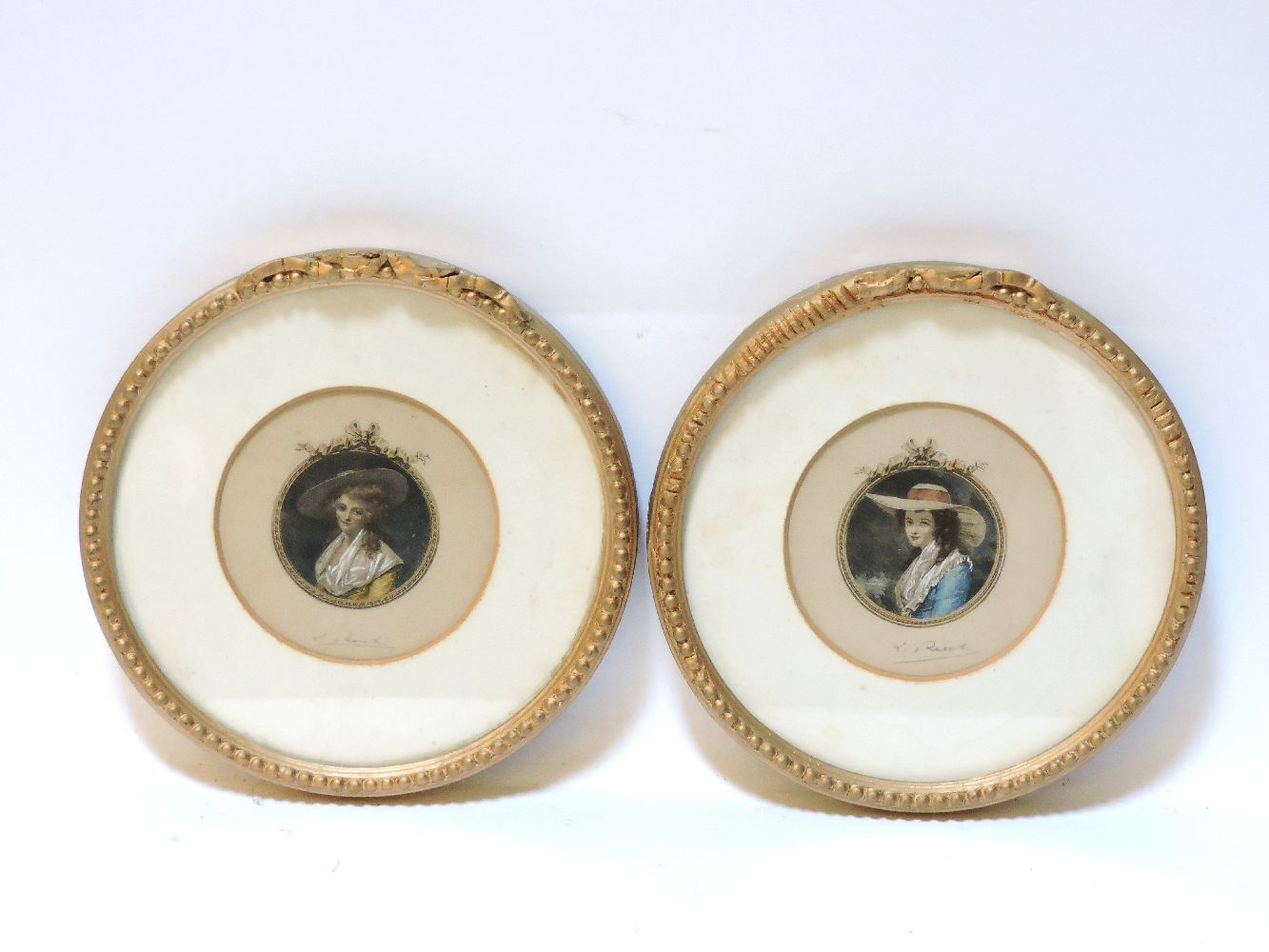 A pair of early 19th century circular hand coloured engravings, signed in pencil