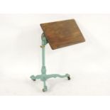 An Edwardian walnut invalid table, on cast iron base, top 38.5 x 67cm